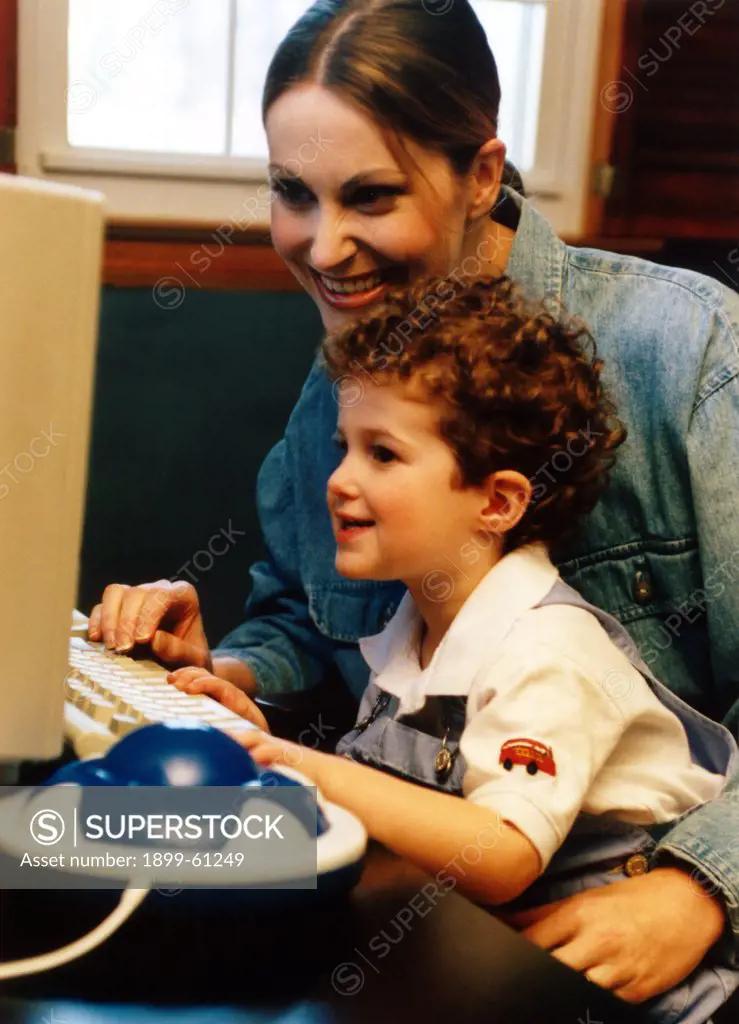Mother And Son Using Computer.