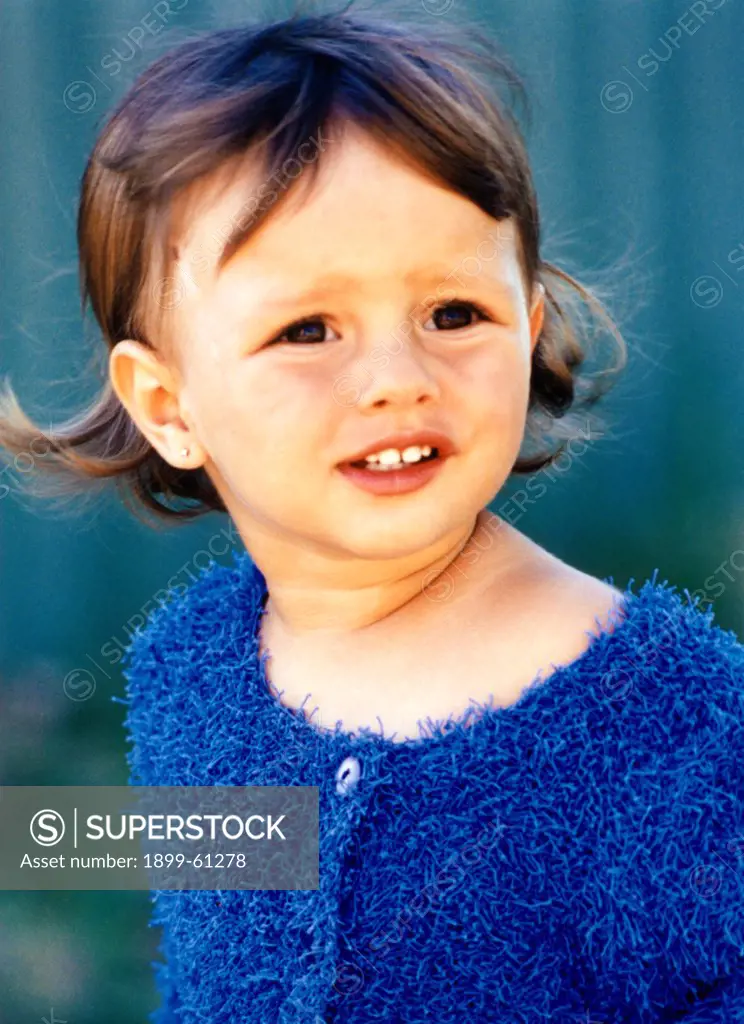 Portrait Of Young Girl In Blue Sweater.