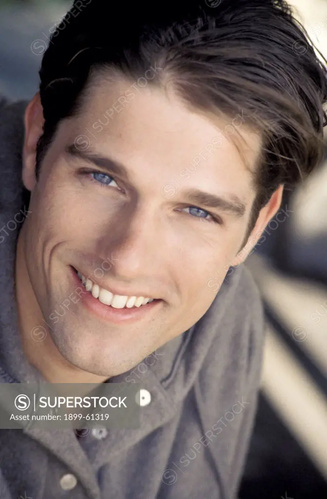 Portrait Of Man Smiling, Wearing Grey Hooded Sweatshirt