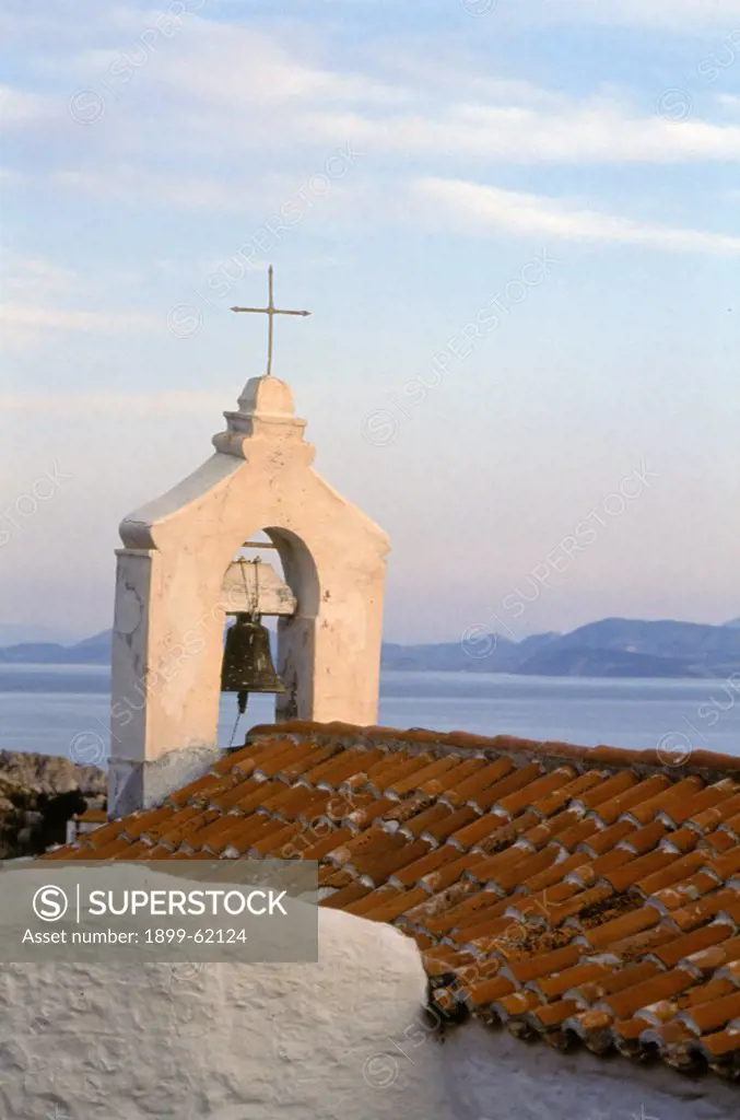 Greece, Hydra, Rooftop With Bell And Cross, Water And Islands In Background