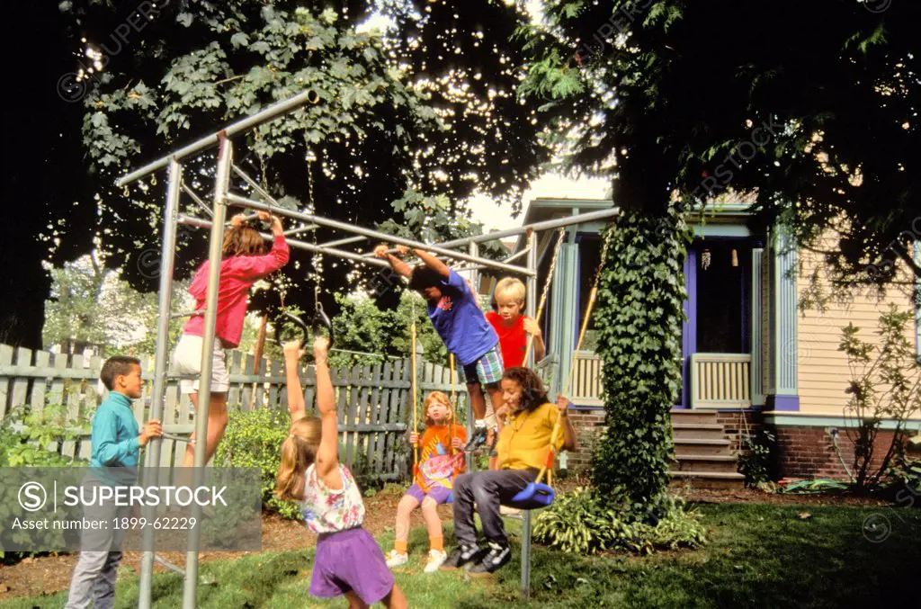 Children Playing Outdoors On Monkey Bars.