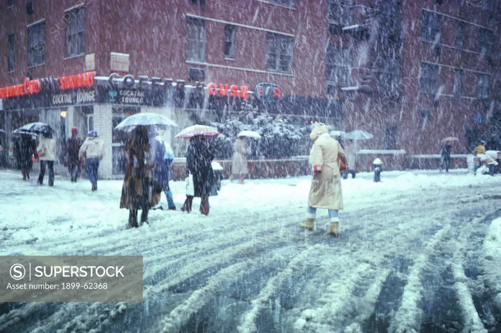 New York City, Winter Street Scene With Snow Falling; People With Umbrellas.