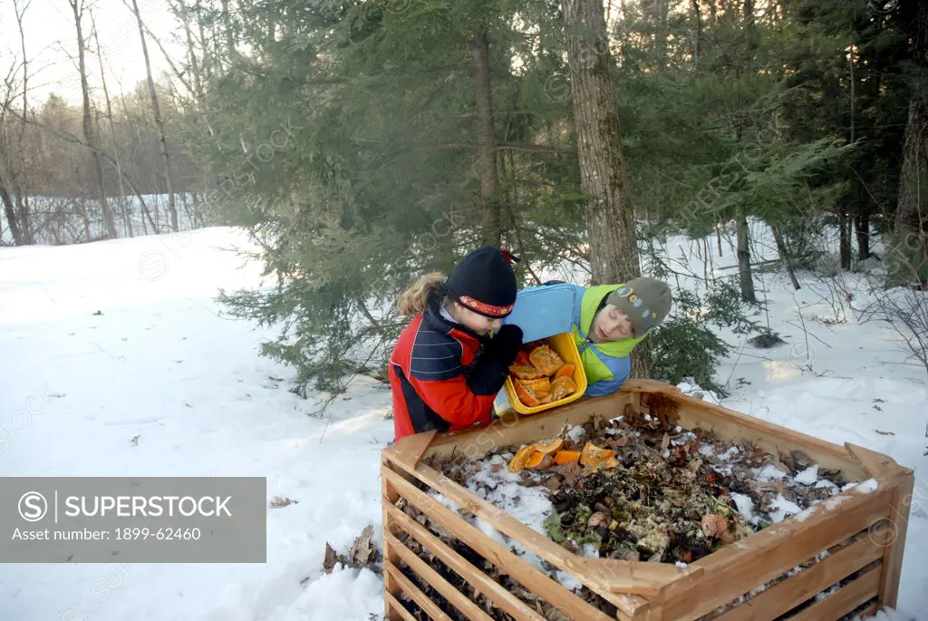 Girl Dumping Food Scraps Into Compost Bin