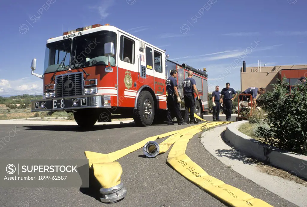 New Mexico. Santa Fe. Firetruck, Firemen Testing Hoses