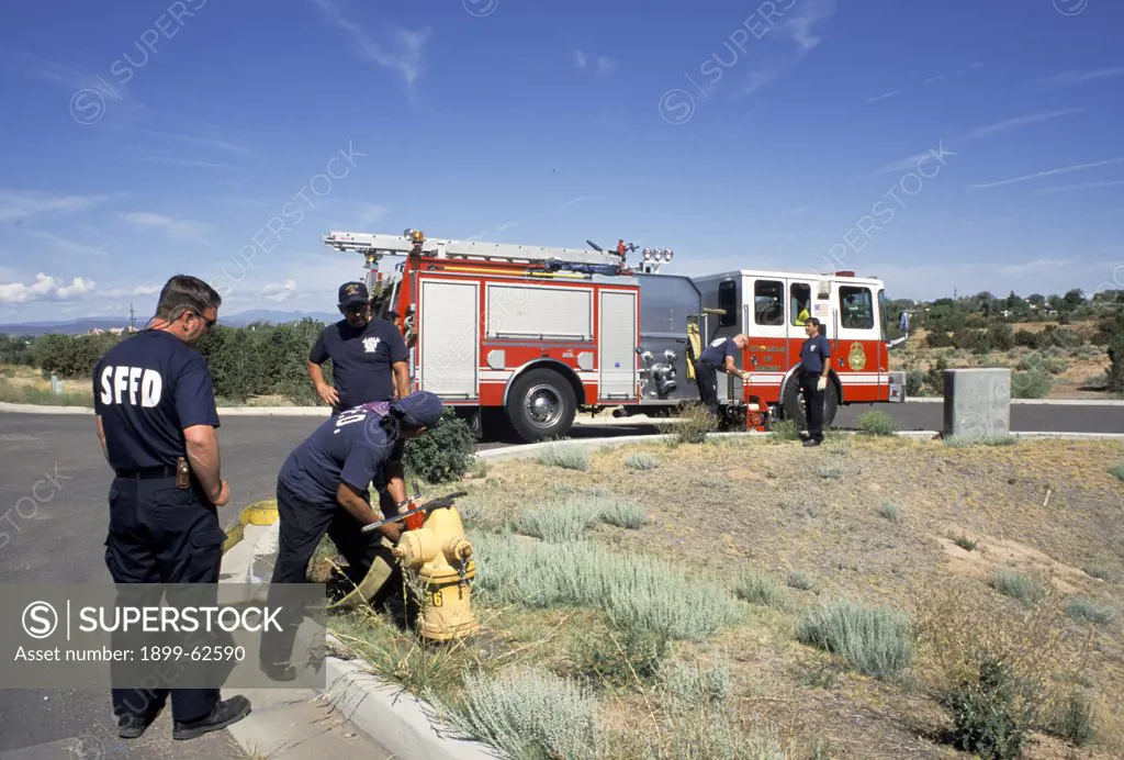New Mexico. Santa Fe. Firetruck And Firemen At Hydrant - Testing Hoses