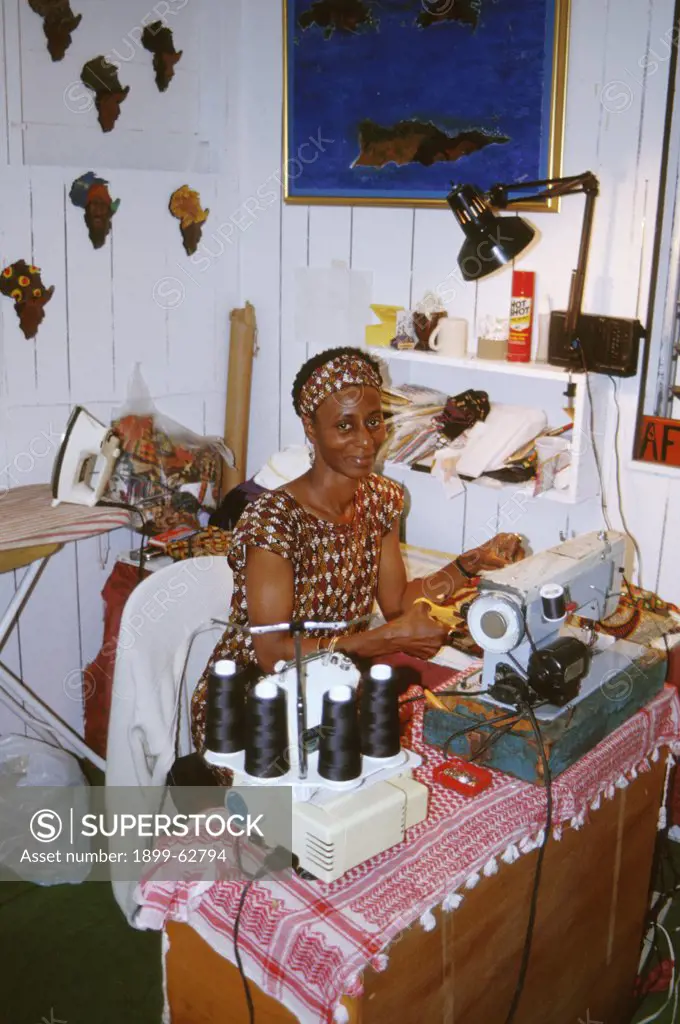 Virgin Islands, St. Thomas. Woman Working At Sewing Machine.
