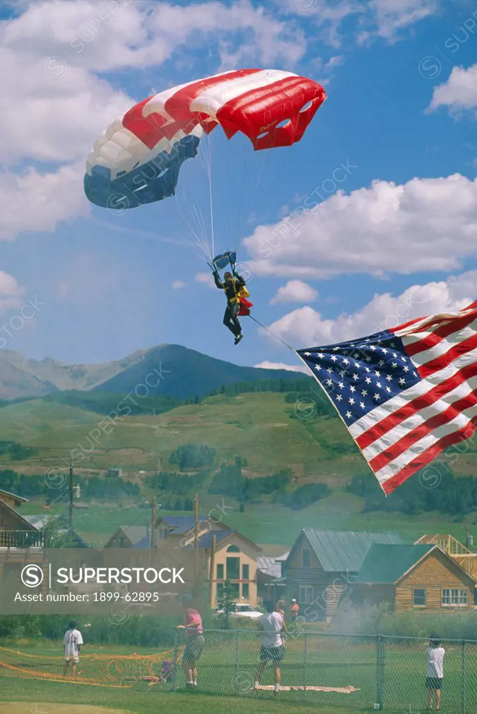 Colorado, Crested Butte. Man Parachuting With American Flag At Aerial Weekend.
