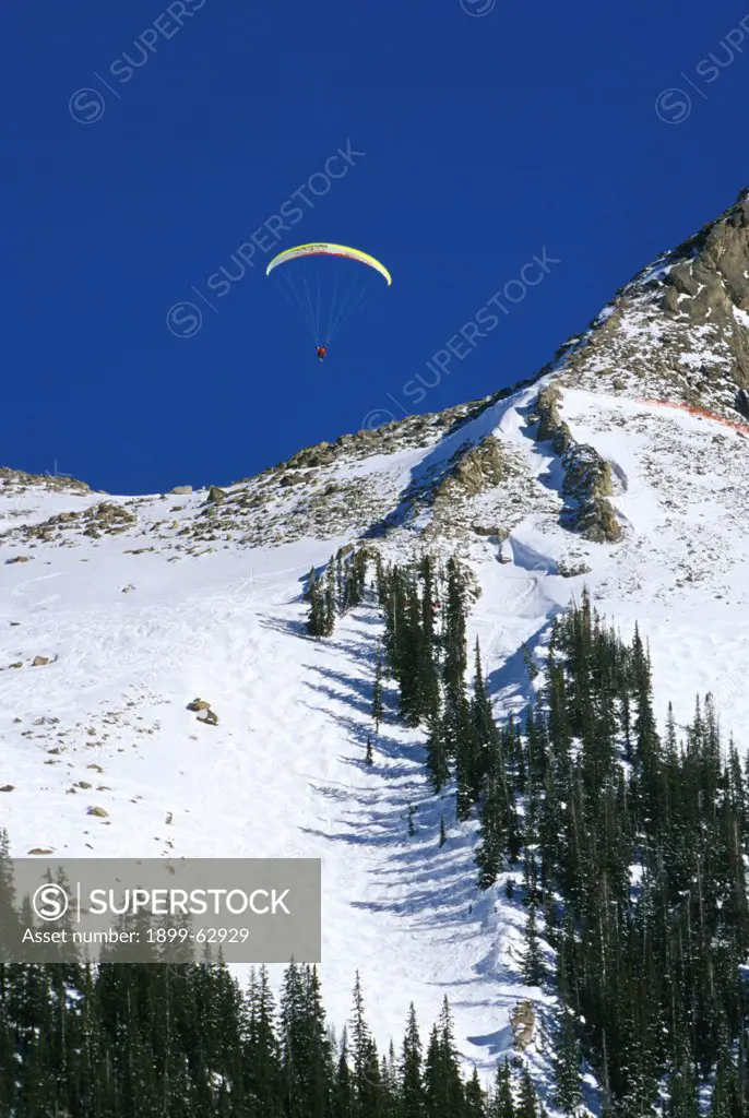 Colorado, Mt. Crested Butte. Man Paragliding In Winter