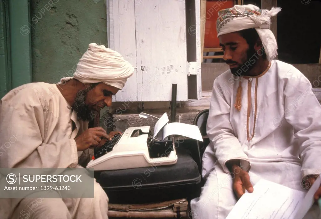 Sultanate Of Oman, Muscat Souk. Arab Scribe At Typewriter