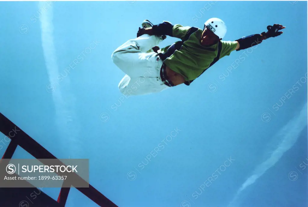 Male Rollerblader Doing An Aerial On A Vertical Halfpipe