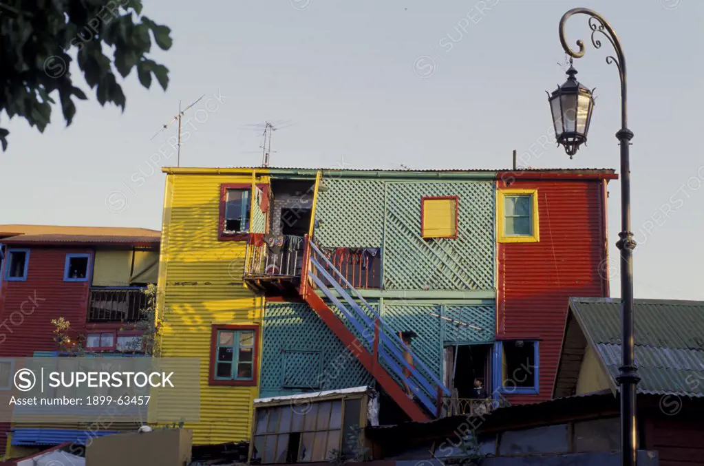 Argentina, Buenos Aires, La Boca Section, Calle Caminito. Multicolored Buildings And Street Lamp.