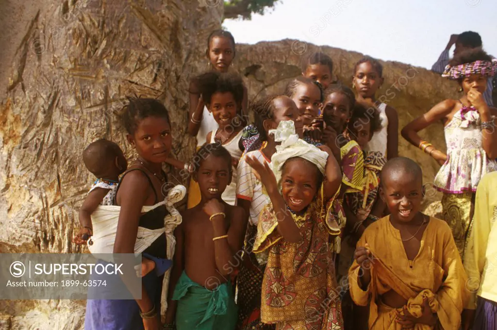 Senegal, MBour Region. Village Children Standing Under Tree, Smiling