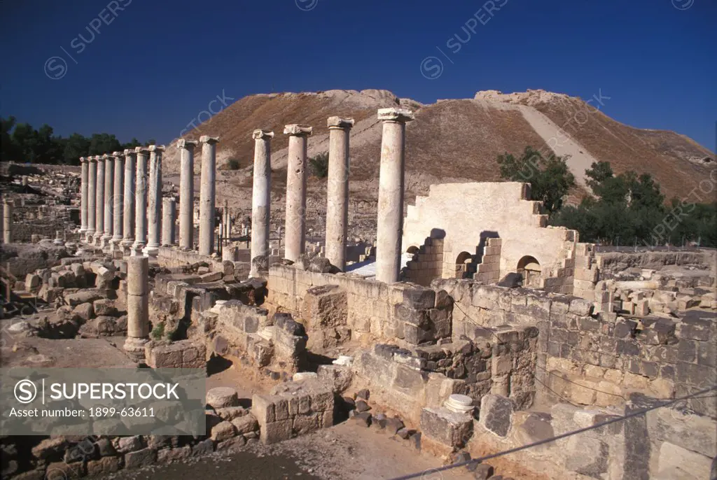 Israel, Beit SheAn. The Roman Colonnade, Silvanus Street, With Tel Beit SheAn In The Background
