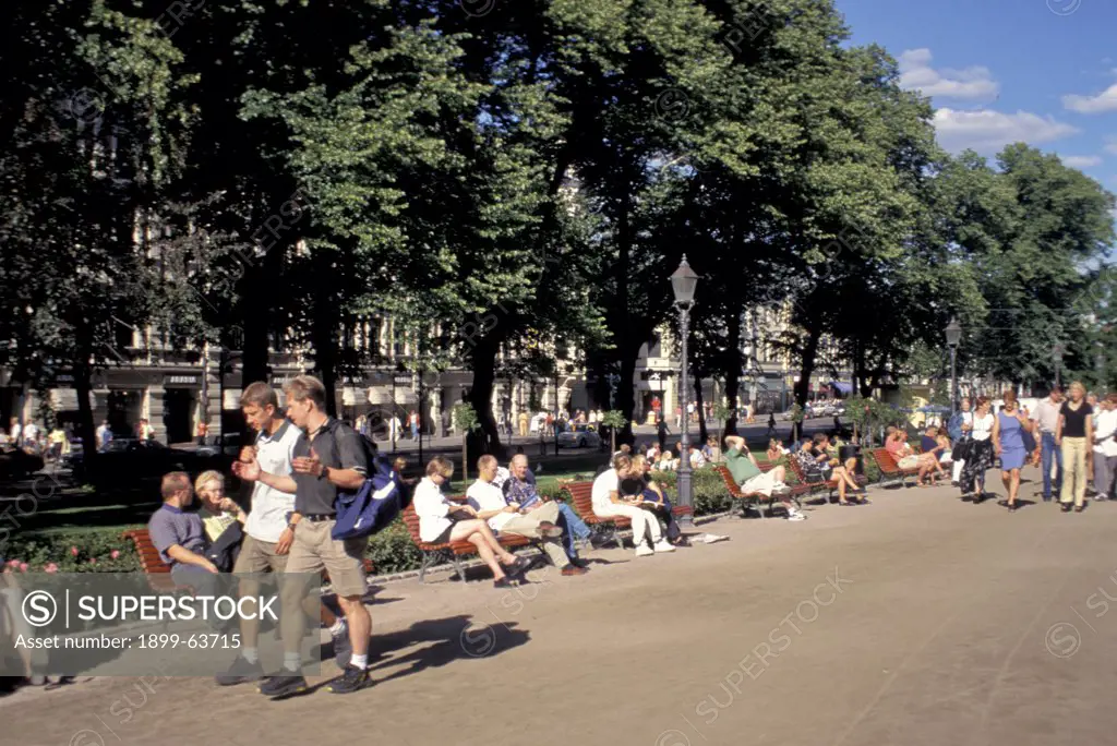 Finland, Helsinki. Esplanadi. People Sitting On Benches And Strolling Down The Esplanade.