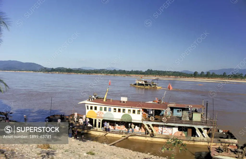 Thailand. Chiang Saen. Unloading Apples From A Boat Along The Mekong
