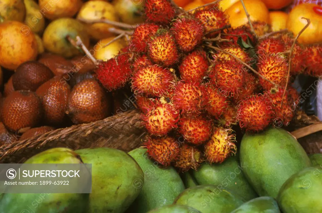 Indonesia. Bali. Ubud. Red Rambutans. Green Mangoes.