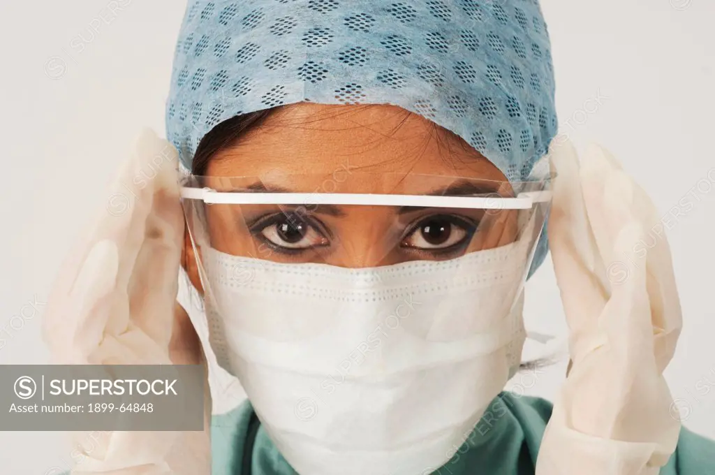 Surgeon putting on surgical eye shield