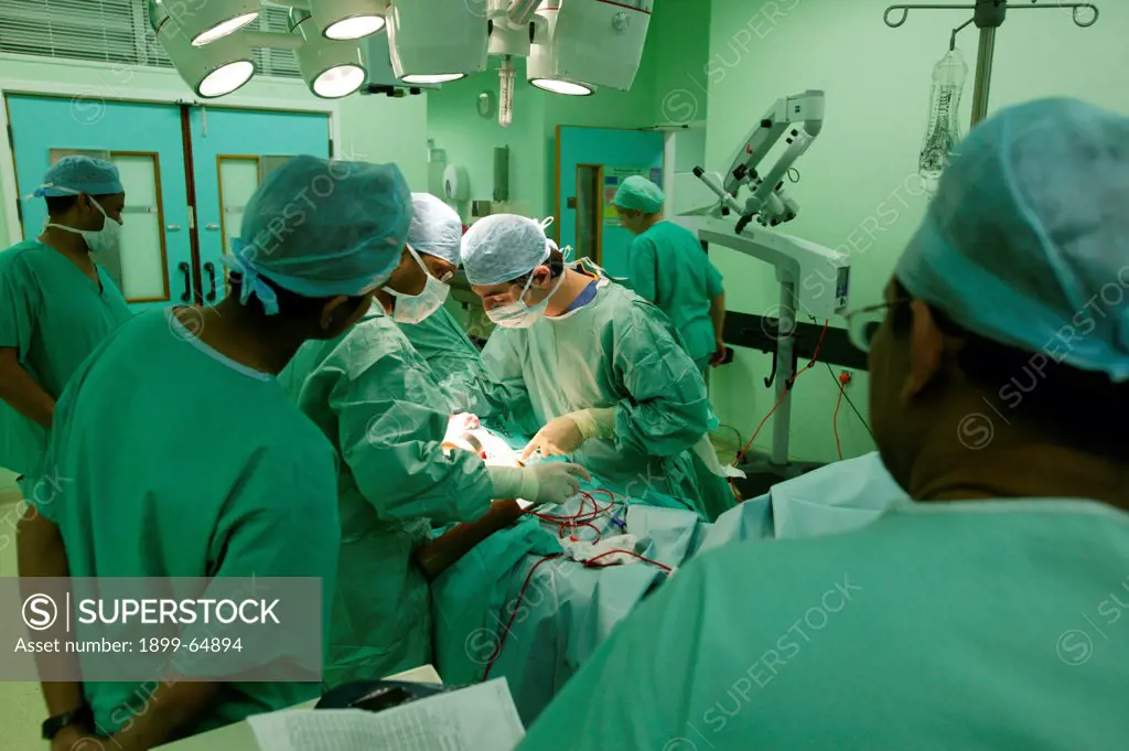Surgeons performing abdominal operation. UK