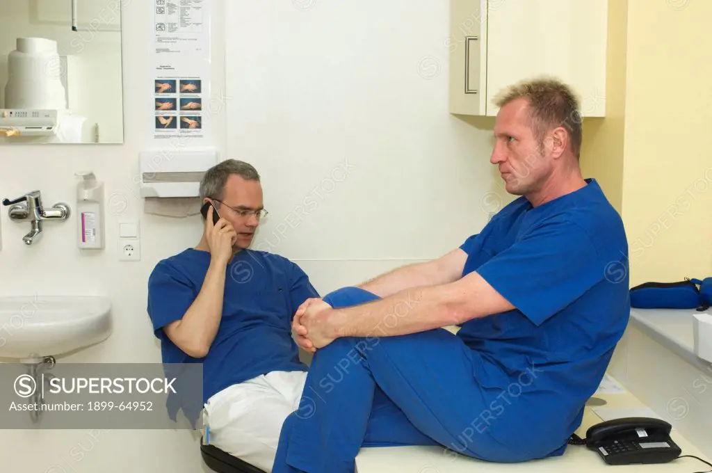 Two male nurses at work station