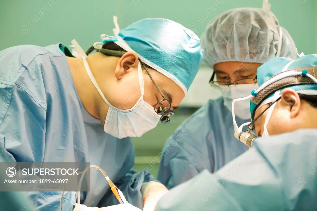 Surgeons operating on patient