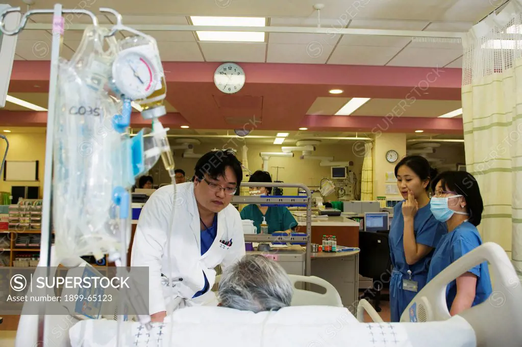 South Korea, Seoul, Samsung Medical Center, medical staff attend to patient on intensive care unit