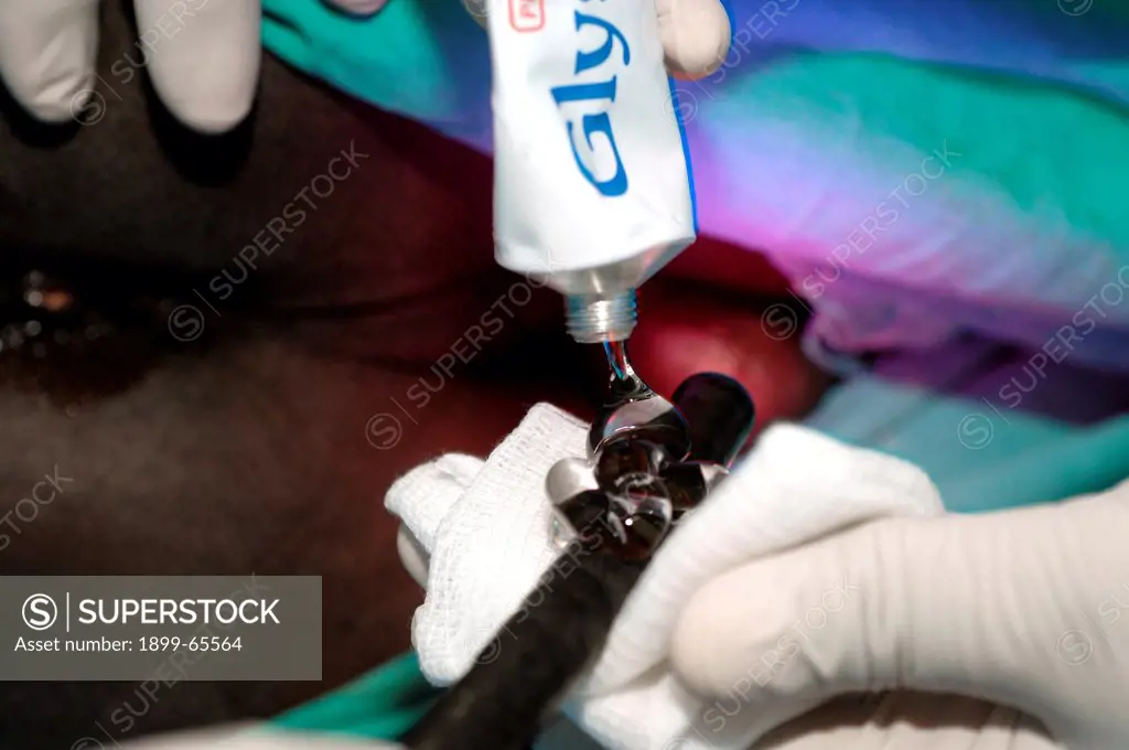 Surgeon applying lubrication to endoscopic probe.