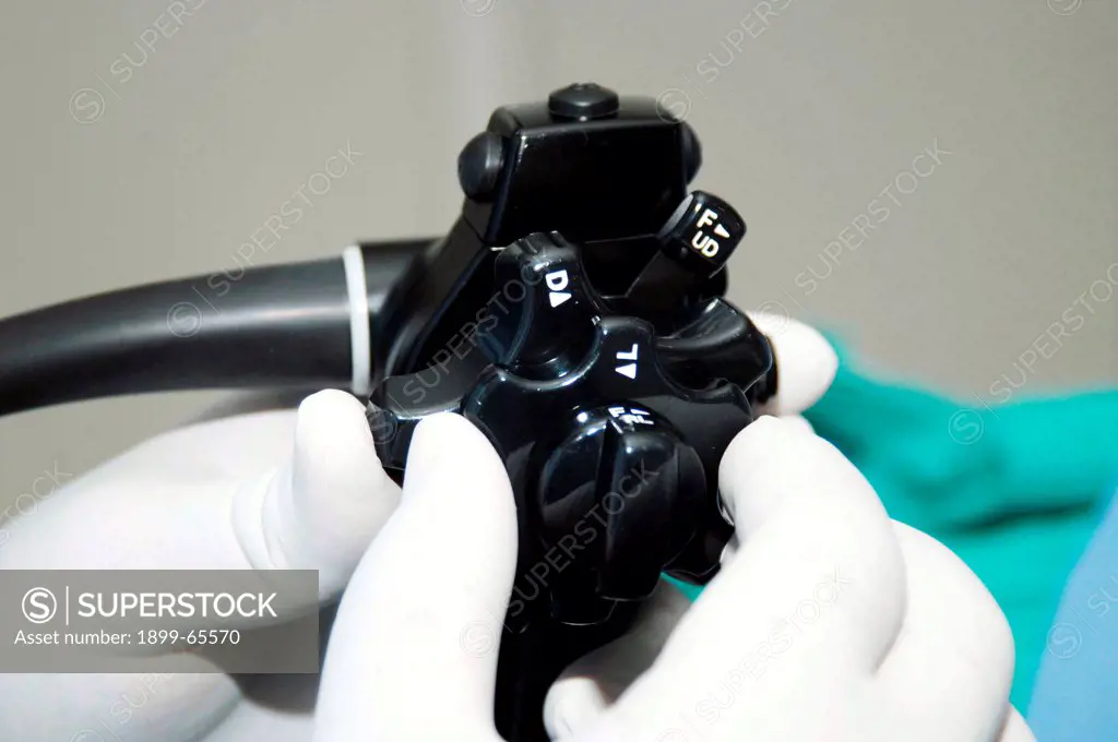 Surgeon holding endoscope.