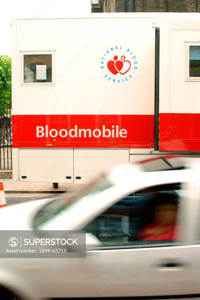 Mobile blood donating unit with passing car, UK