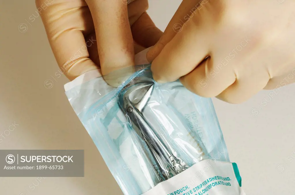 Dentist opening sterilized package containing forceps