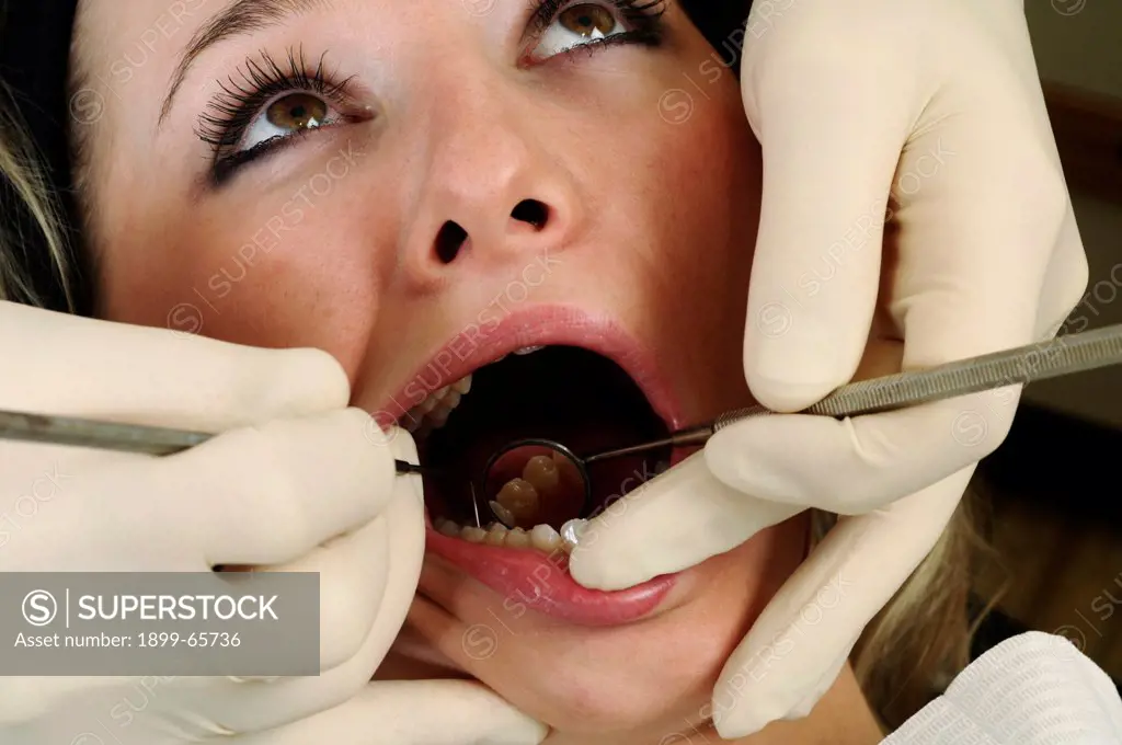 Dentist giving women soft tissue dental examination