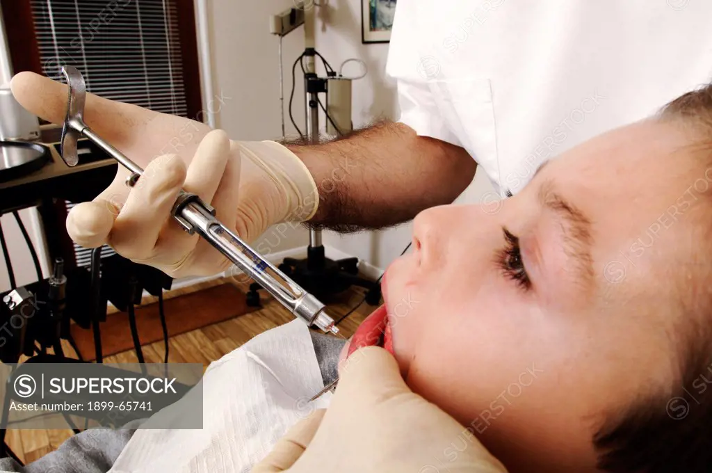 dentist injects boy with numbing injection