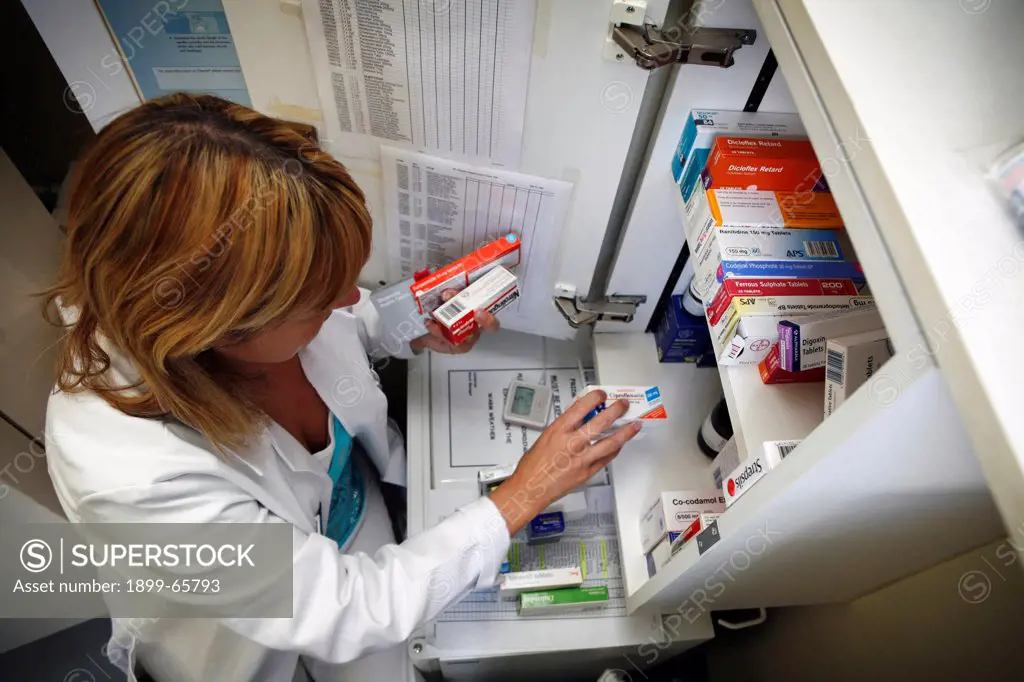 Female pharmacist checks stock levels of hospital