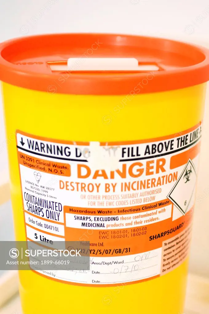 Yellow container for disposal of sharps,