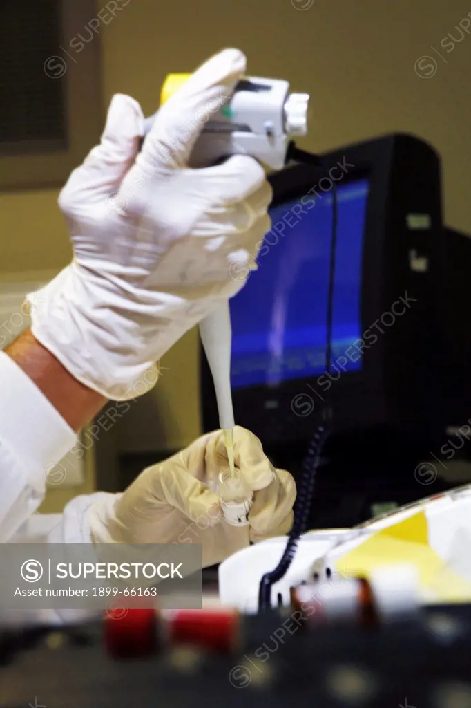 Pathologist using electronic pipette to accurately
