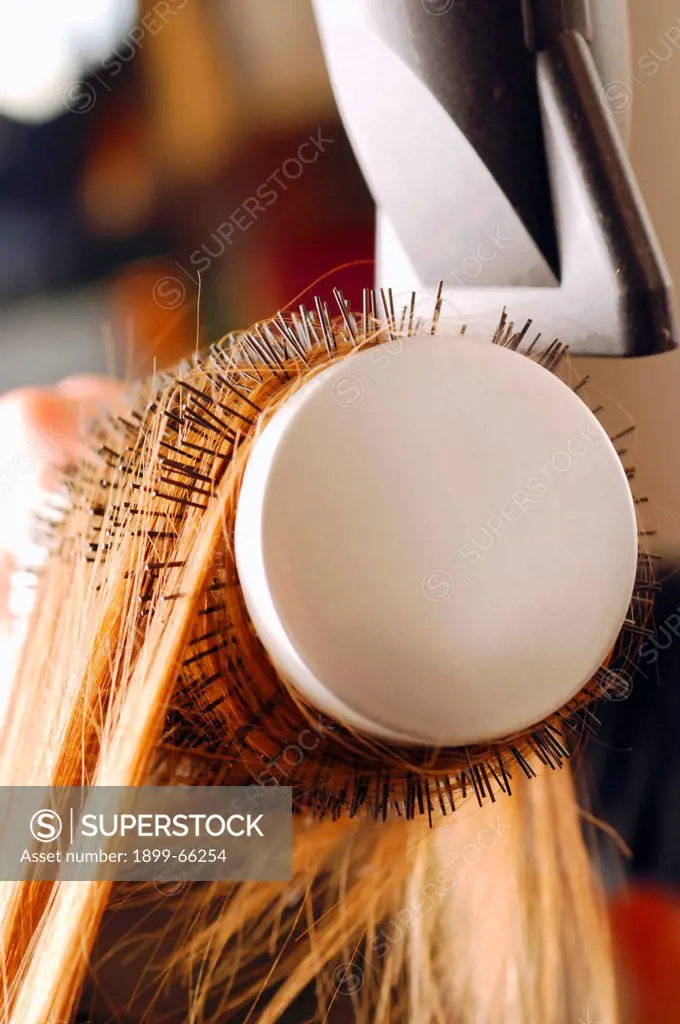 Close up of hair being brushed and dried with hair dryer