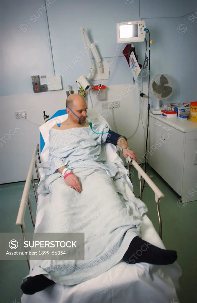 Male heart attack sufferer laying in bed with supply