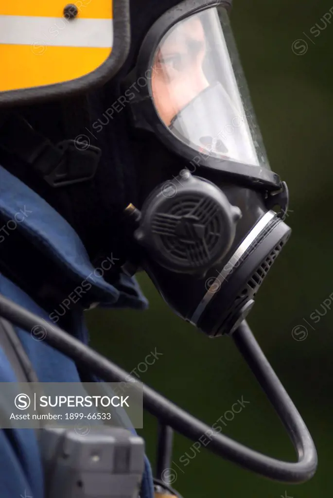 Close-up of firefighter wearing gas mask