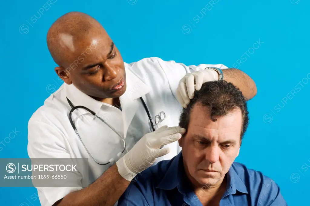 Male nurse examining hair of his patient for nits