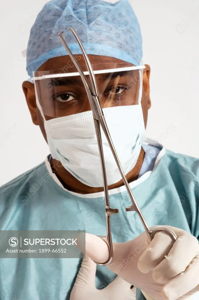 Portrait of surgeon dressed in protective wear holding