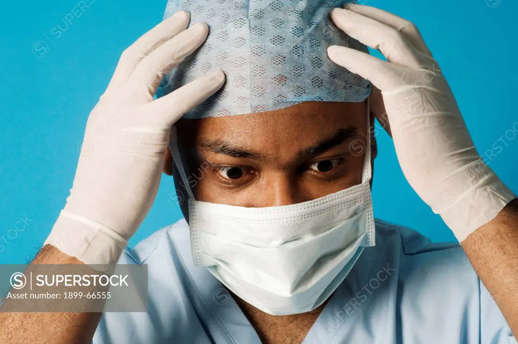 Surgeon holding his head in disbelief