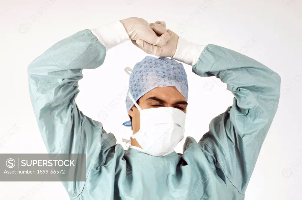 Studio shot of surgeon wearing green surgical gown,