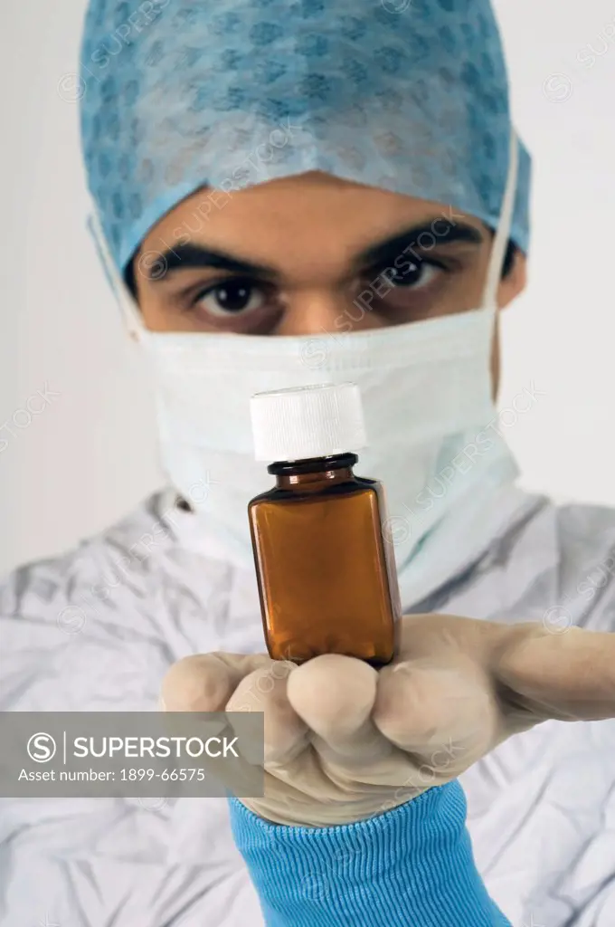 Portrait of surgeon holding medicine bottle in his hand