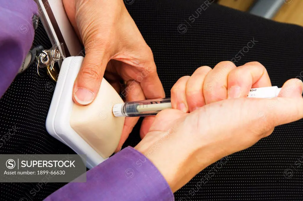 Woman showing hormone injections pen to patient,
