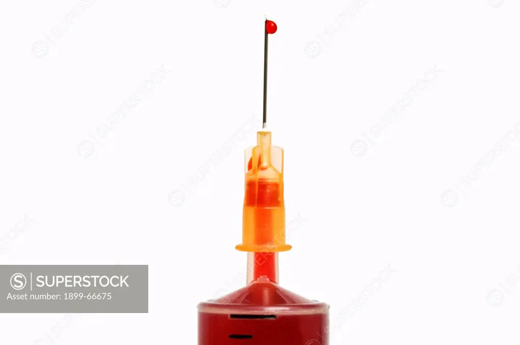 Droplet of blood on tip of syringe needle