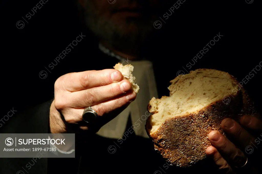 Protestant minister holding communion bread