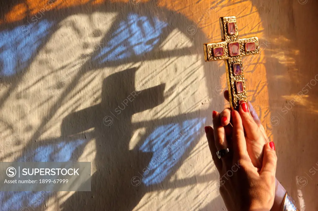 Woman holding a cross.