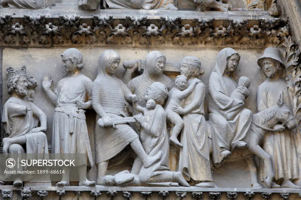 Notre Dame Cathedral. North facade. Cloister gate tympanum sculpture depicting the massacre of the innocents and the flight to Egypt