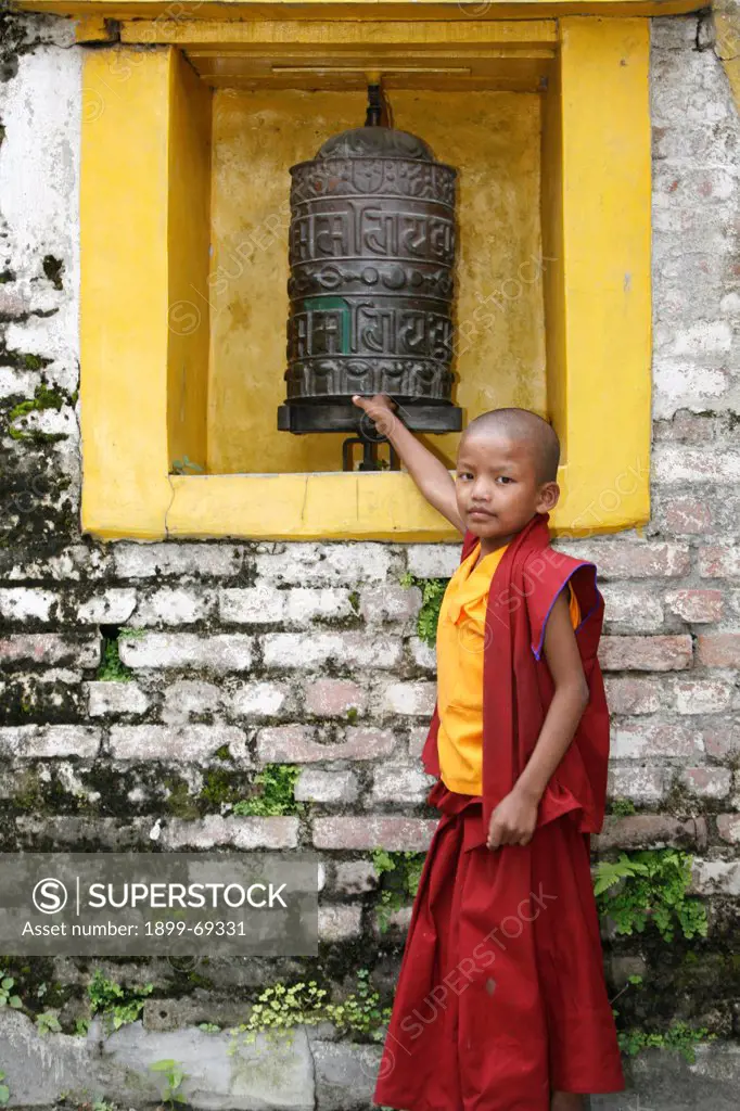 Young monk and prayer wheel. Swayambunath temple.