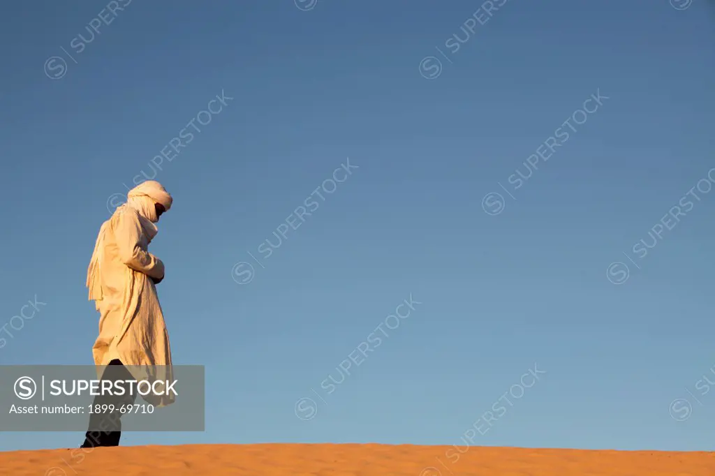 Beduin praying in the Sahara