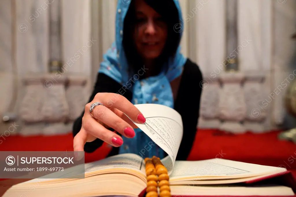 Woman reading the Coran in a mosque